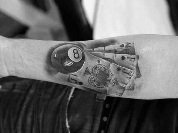 A tattoo of a billiard ball with a gambling symbol